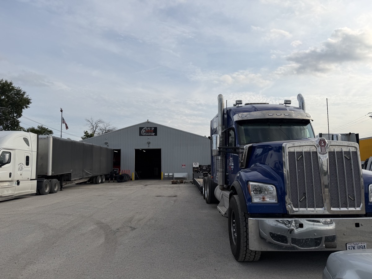 Kenworth semi truck with a flatbed trailer outside I-255 Truck & Trailer Repair in Sauget, IL